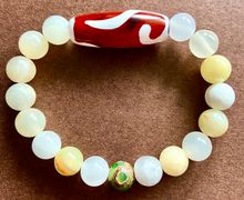 Браслет из оникса с тибетскими бусинами Дзи Золотой ключ и 3 глаза