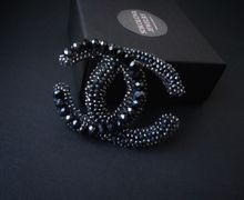 Black brooch with zircons