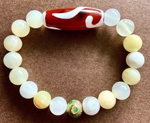 Браслет из оникса с тибетскими бусинами Дзи Золотой ключ и 3 глаза