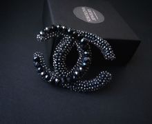 Black brooch with zircons