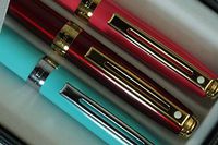 Sheaffer Signature Prelude Lightning Pearlescent Signature Trio of Hot Pink with 22KT Gold, Red with 22KT Gold and Turquoise with Nickel Medium Ballpoint pens.All Adorn Sheaffer Dots of Excellence
