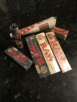 RAW Sampler Pack- Clipper Lighter, 4 Pack RAW Rolling Papers (Classic King Sized Slims, Organic King Size Slims,Black King Size, Black 1 1/4), King Sized Organic Cones, Original Unrefined Tips