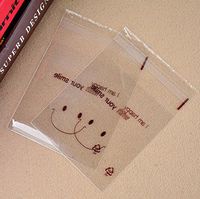 100PCS 10cm x 10cm/3.9'' x 3.9'' Lovely Plastic Transparent Sealing Soap Cookies Candy Bakery Packing Bag Food Grade Biscuits Packing Container (Smiling)