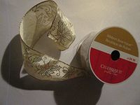 2.5 in x 25 ft. Platinum/Gold Pointsetta on sheer white Designer Ribbon