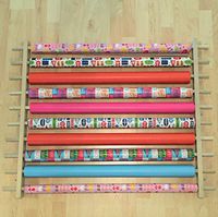 Storage Station, Organizer, Dispensing Rack for Gift Wrapping Paper, Ribbons, Cellophane & Other Crafts or Wrap Items on a Roll. Holds 10 Rows. Adjustable Width. Easy Wall Mount. Hardware Included.