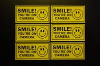 Smile You're On Camera Security Stickers Vinyl Decals (6 Pack) Indoor Outdoor Waterproof Self Adhesive 4" X 2" (X6PS61)