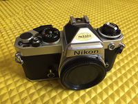 Chrome Nikon FE SLR film camera; body only, lens is not included